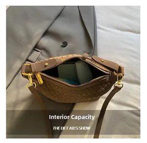 Detail view of woven leather bag interior showing large capacity for phone and accessories