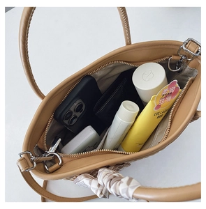 Top view showing spacious interior with zipper pocket of the light brown crossbody bag