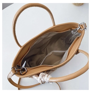 Top view of spacious khaki crossbody bag with internal pocket and silk scarf detail