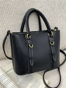 Black matte leather bucket bag with white stitching and gold hardware shown at 45-degree angle