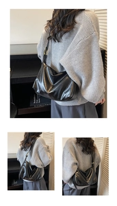 Close-up of black PU leather shoulder bag with gold buckle and embossed fashion logo
