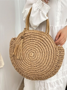 Bohemian woven straw handbag with circular design and tassel detail for summer vacations