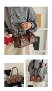 Detail view of brown faux leather bowling bag with twin front pockets and silver hardware