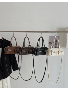 Multiple colors of faux leather bowling bags with front pocket details and metal rings
