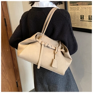 Detail view of the elegant beige leather hobo bag showing pleated design and texture