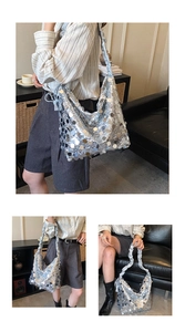 Detail of silver sequin tote bag with ruffled shoulder strap and reflective metal sequins