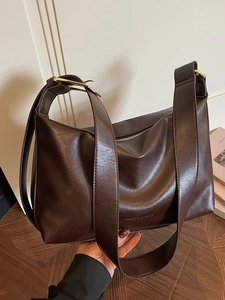 Retro deep brown large capacity tote bag with wide strap and golden hardware in lifestyle setting