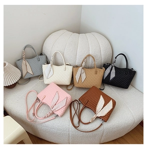 Quilted tote bags in six colors featuring decorative silk scarves and adjustable straps