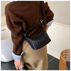 Detail of black woven leather shoulder bag showing the classic Intrecciato craftsmanship
