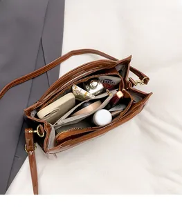 Internal view showing spacious compartments and storage of a brown snakeskin pattern bag