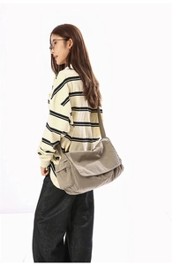Detail view of large corduroy crossbody messenger bag with side zipper pocket