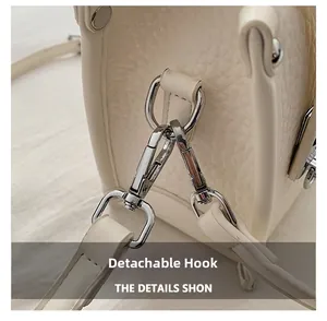 Close-up of pebble leather texture and detachable silver metal hook on the bag