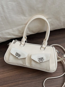 Minimalist cream white bowling bag with dual front pockets and silver hardware