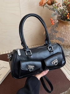 Black vegan leather Boston bag with dual pockets, silver buckles, and a long shoulder strap