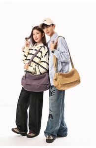 Close-up of canvas messenger bag with adjustable strap and flap cover in two colors