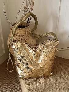 Elegant gold sequin tote bag with pleated shoulder strap for party and evening use