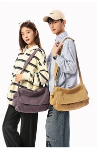 Detail of canvas messenger bag showing large capacity and adjustable wide shoulder strap