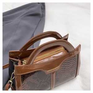 Macro detail of brown snakeskin embossed texture with golden Fashion & Bags logo lettering