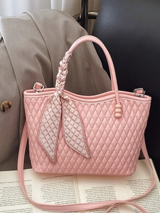 Pink quilted handbag with silk scarf handle and silver hardware in magazine setup