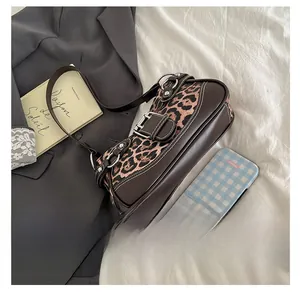 Detail of vintage leopard print crescent bag with leather trim and metallic buckle