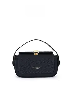 Detail of black leather handbag with gold wave metal buckle and elegant textured finish