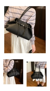 Detailed views of a black pebbled leather tote bag with buckle decor and teardrop pendant