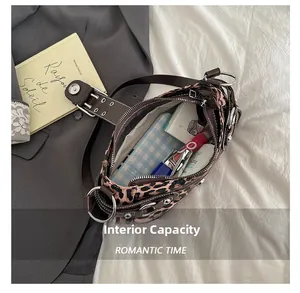 Spacious interior of leopard print handbag showing phone and cosmetic storage