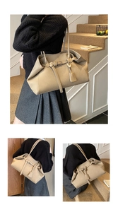 Detailed close-up of a large beige tote bag featuring high-quality lychee grain texture