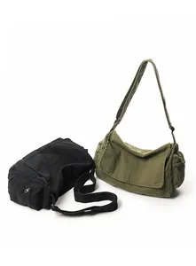 Detailed view of washed canvas messenger bags in army green and black with side pockets