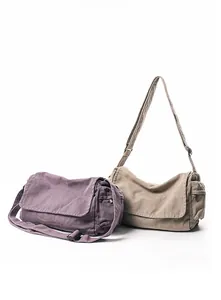 Detail view of washed canvas messenger bags in purple and khaki with side zipper pockets