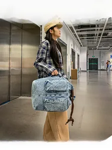 Spacious washed denim tote bag with cargo pockets and rope details for travel