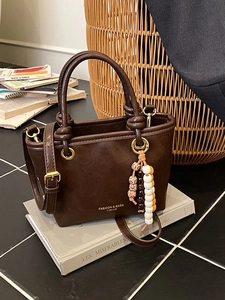 Retro dark brown leather crossbody tote bag with knot handle and beaded tassel accessory
