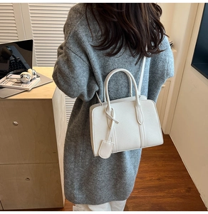 Vue de dos d'un modèle portant un sac fourre-tout en cuir blanc à texture litchi élégant