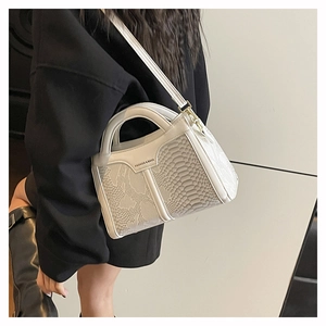 Detail showing white snake-embossed pattern and metal buckle on fashionable crossbody bag