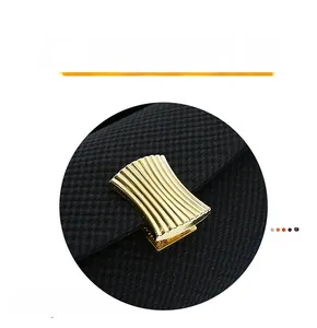 Detailed macro view of black textured handbag featuring elegant gold fan-shaped metal clasp