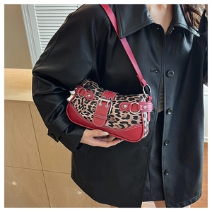 Detail of vintage leopard print armpit bag with red leather trim and silver buckle