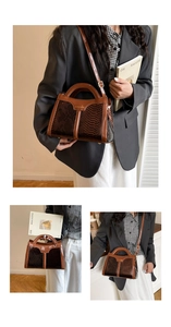 Detail of brown python print square bag showing premium snake texture and hardware