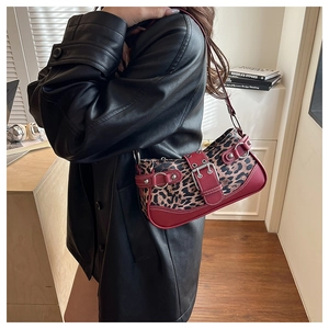 Detail of vintage leopard print shoulder bag with red leather straps and silver metal hardware