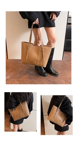 Detail of a large vintage brown tote bag showing textured grain and buckle straps