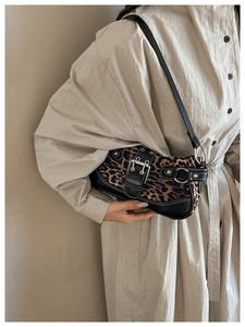 Detail of leopard print shoulder bag with silver hardware and faux leather patchwork