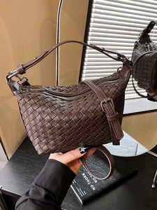 Retro deep brown woven leather dumpling bag with adjustable shoulder strap and silver buckle