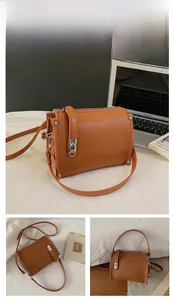 Detail of brown litchi pattern leather bag showing accordion structure and metal clasp