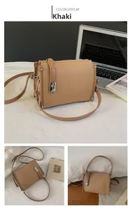 Detail of khaki leather bag with silver metal lock and textured lychee pattern finish
