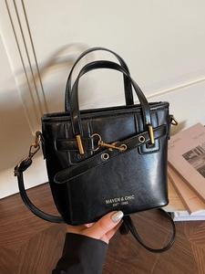 Vintage black leather handbag with gold buckle and crossbody strap for elegant women