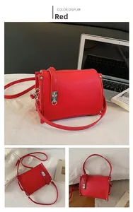 Macro detail of red lychee grain leather handbag featuring a silver metal push lock closure