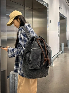 Large black washed canvas backpack with drawstring and dual front zipper pockets