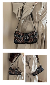 Detailed view of leopard print baguette bag with buckle straps and silver hardware