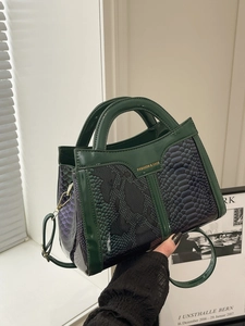 Dark green snakeskin pattern crossbody bag with top handle and gold hardware