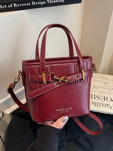 Deep wine red matte leather tote bag with gold buckle and adjustable crossbody strap