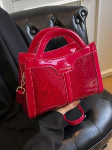Fashionable red snakeskin pattern crossbody handbag with golden hardware and long strap